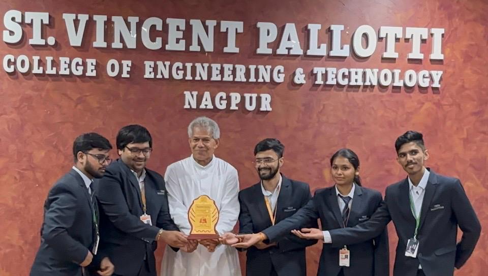 Team receiving award from college director